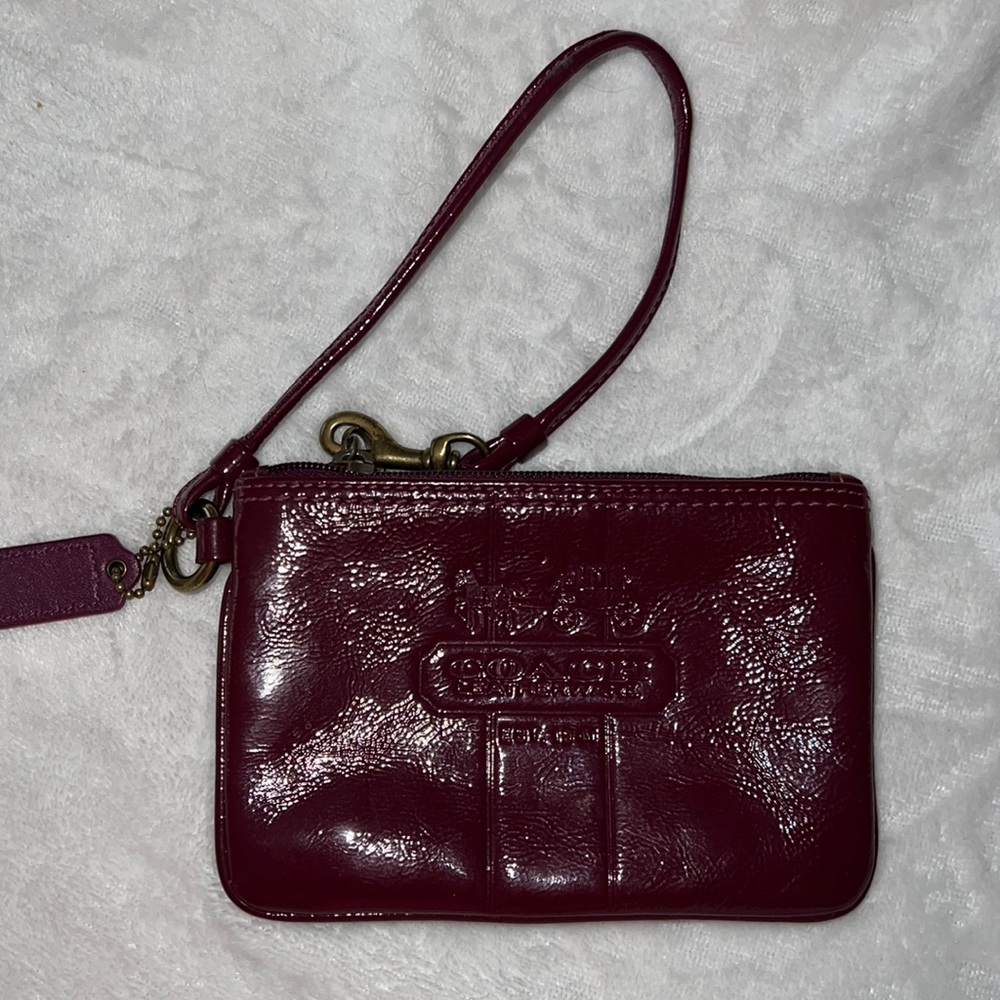 Coach burgundy wristlet plaid inside.  Very good condition.